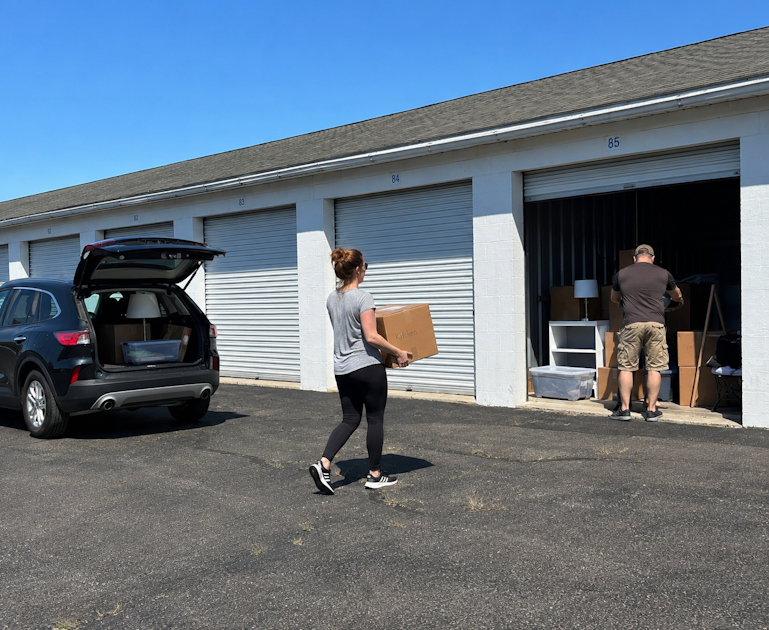 Couple moving items into their storage unit